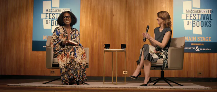 Sintara Golden being interviewed at a book fair.