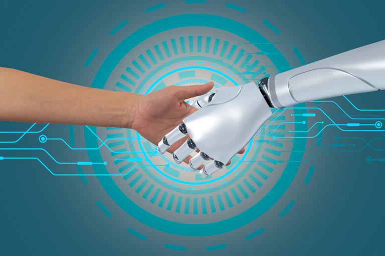 A human hand shaking a robot hand