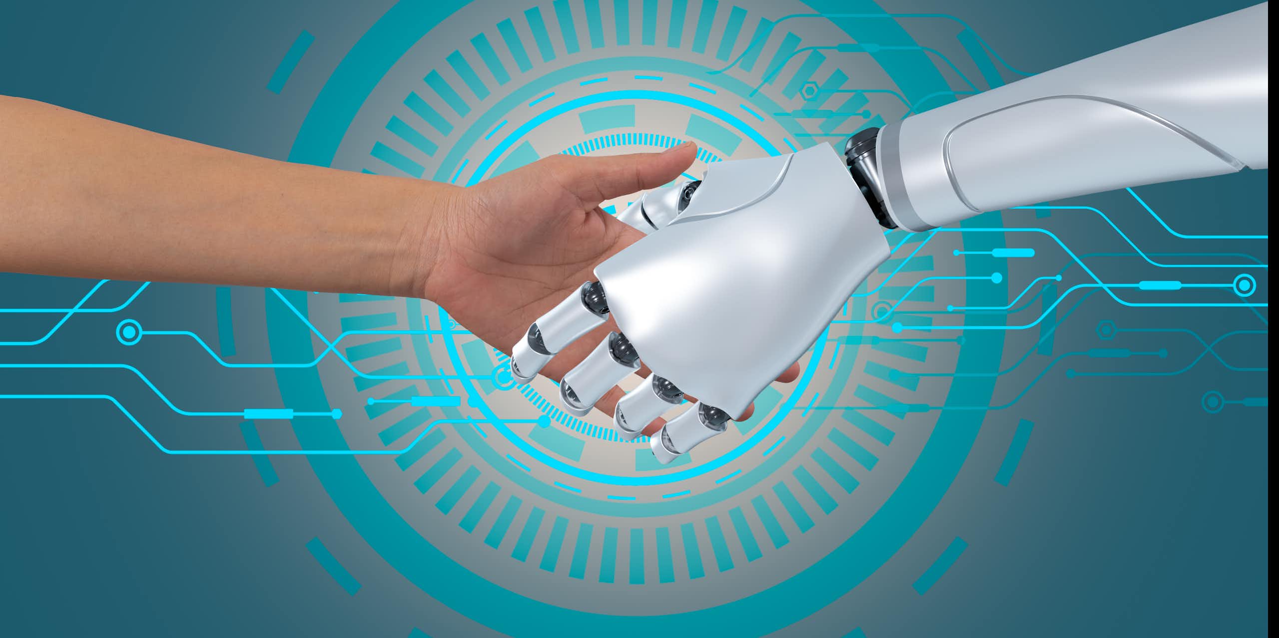 A human hand shaking a robot hand