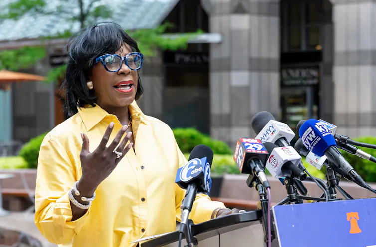 Philadelphia Mayor Cherelle Parker stands in front of microphones