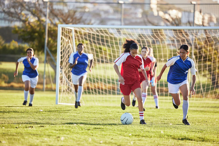 Teenage girls playing soccer.