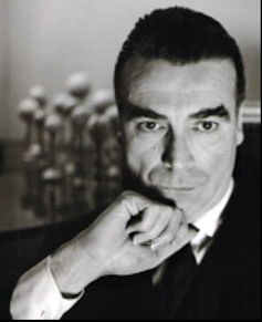 A dark-haired man in a smart suit.