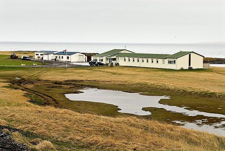 A low building in a remote landscape.