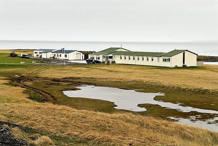 A low building in a remote landscape.