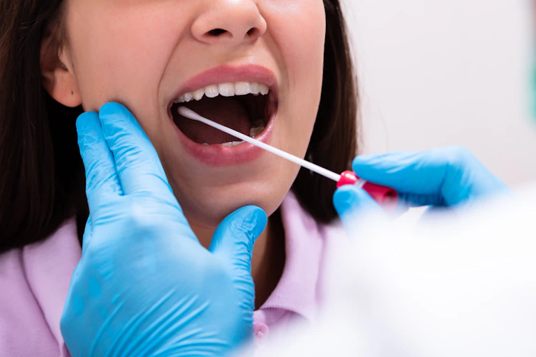 Woman having her mouth swabbed