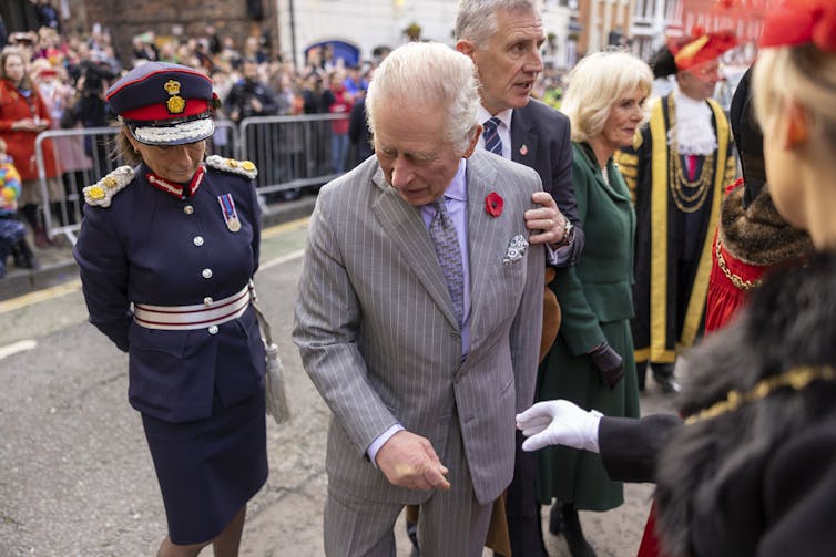 British king reacts after egg is thrown at him.