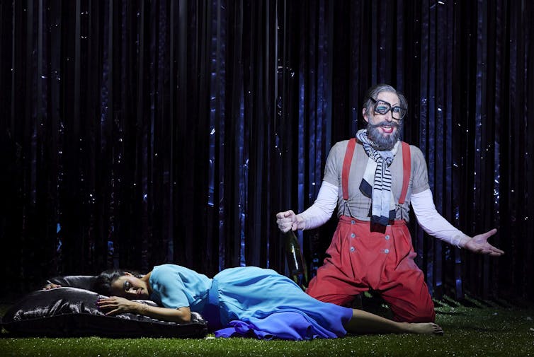Stacey Alleaume is lying on stage in the role of Pamina. Next to her is Kanen Breen as Monostatos.