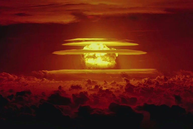 An ominous mushroom cloud bathed in an eerie red-orange glow