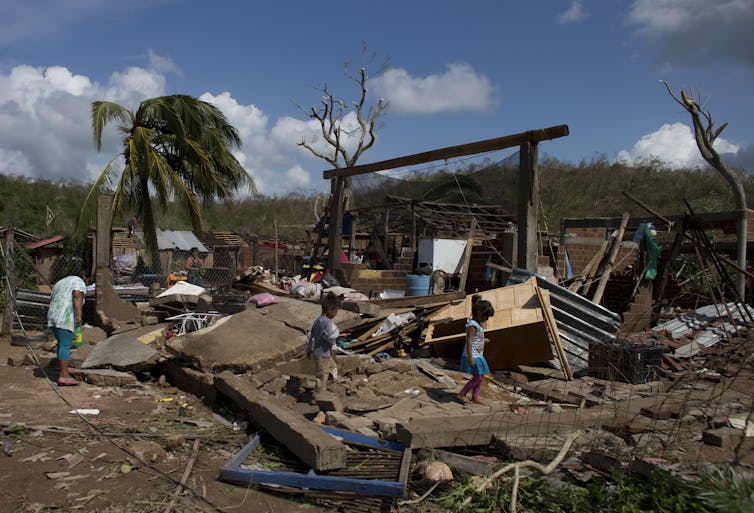 residents look at their houses destroyed by Hurricane Patricia