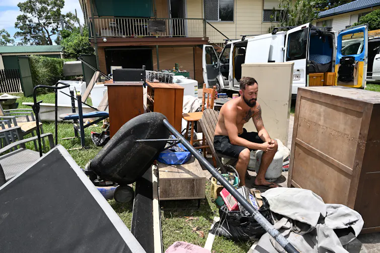 man with his belongings after a cyclone