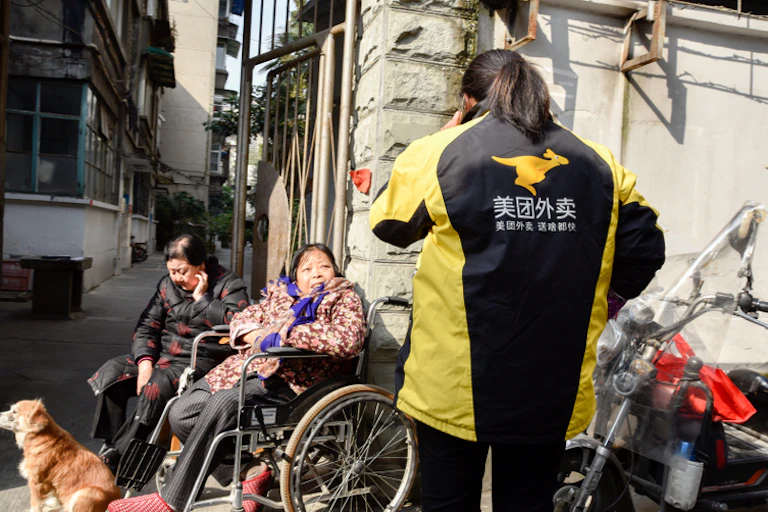 Female delivery rider dismounting
