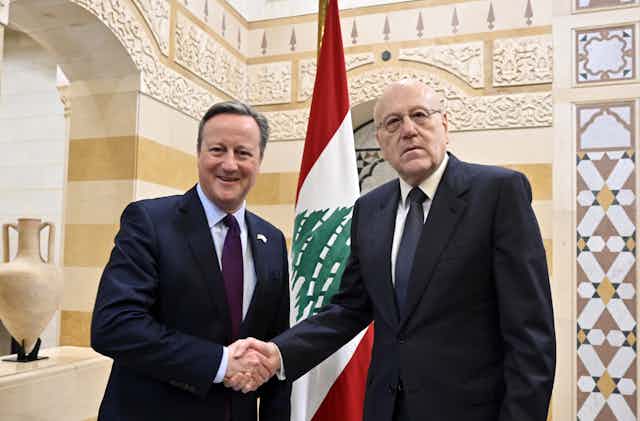 UK foreign secretary David Cameron shakes hands with Lebanese caretaker Prime Minister Najib Mikati 