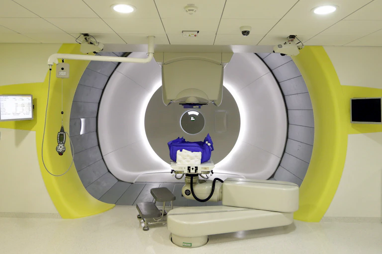 A large cylindrical medical apparatus with yellow sides
