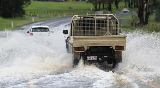 ute driving through floodwater