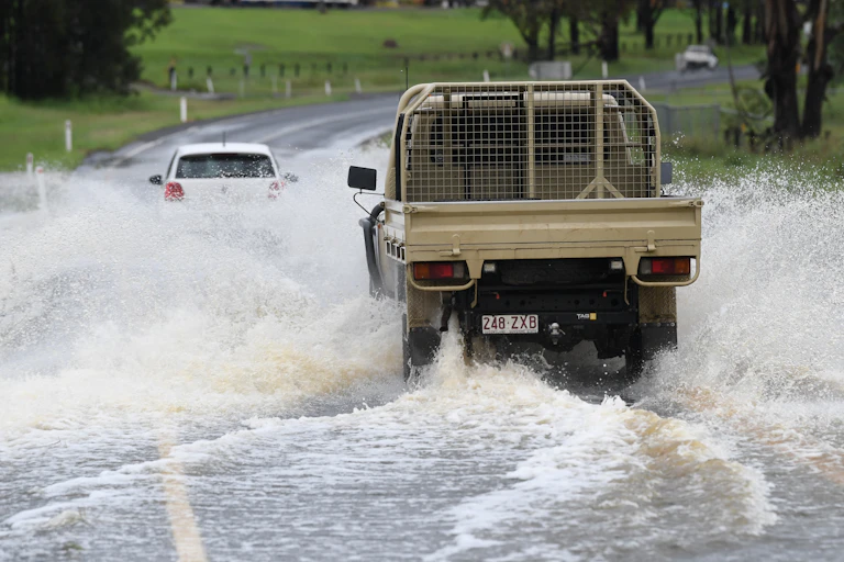 ute driving through floodwater