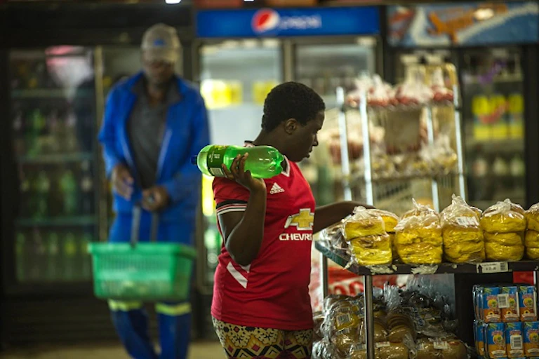 A woman and a man in a grocery store.