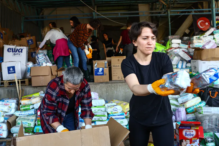 Aid workers in a warehouse distributing relief.