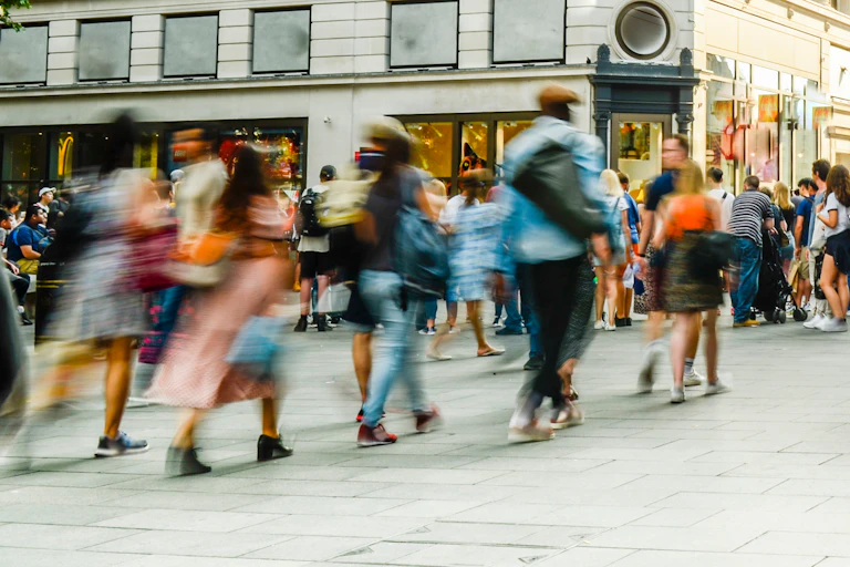 A busy London street with blurry, anonymised people