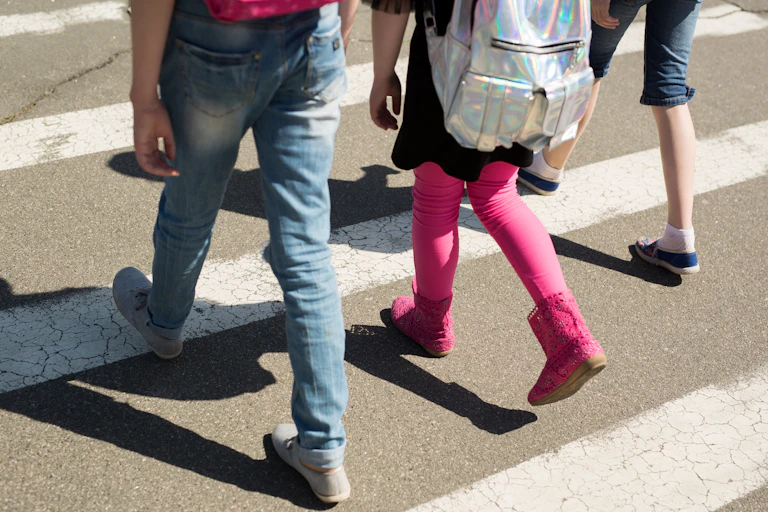 Young people walking across the street