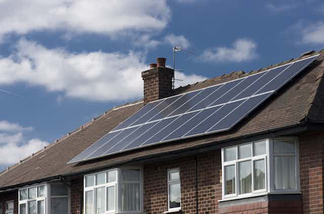 A terraced house with solar panels on the roof.