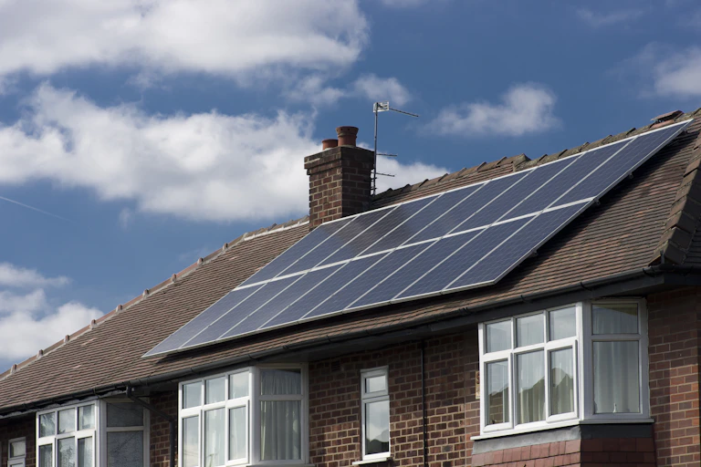 A terraced house with solar panels on the roof.