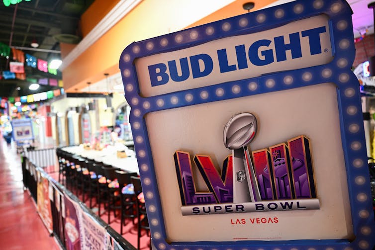 A sign reads 'Bud Light' with the logo of Super Bowl LVIII.