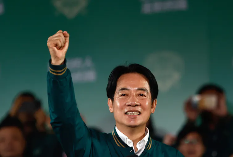 Taiwan's new gesturing to a crowd during a rally.