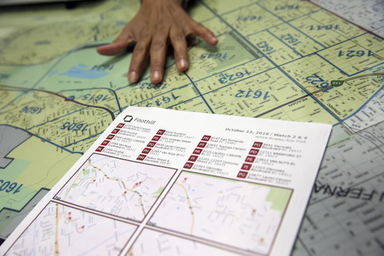 a hand rests on a city map