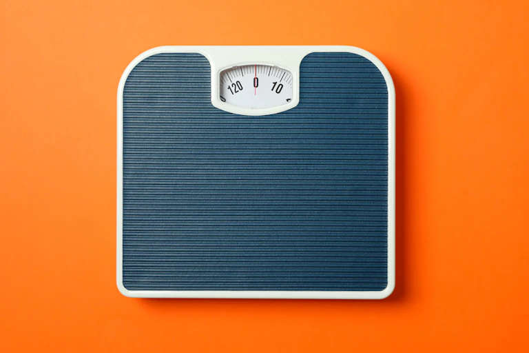 Une balance grise sur un fond orange