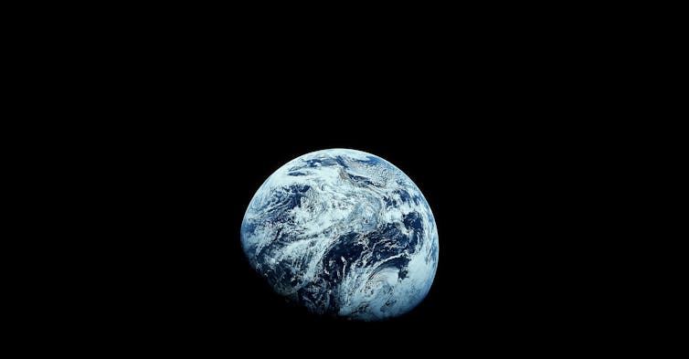 Earth, shown from space, against a dark background.