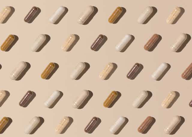 vitamin capsules on beige background