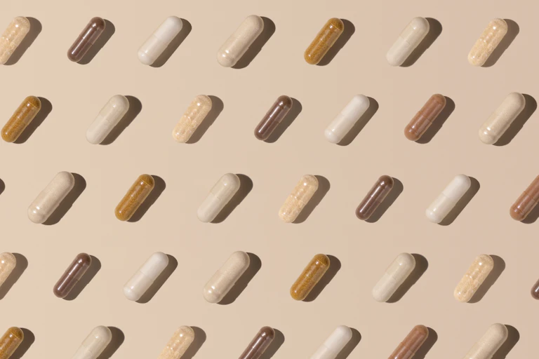 vitamin capsules on beige background