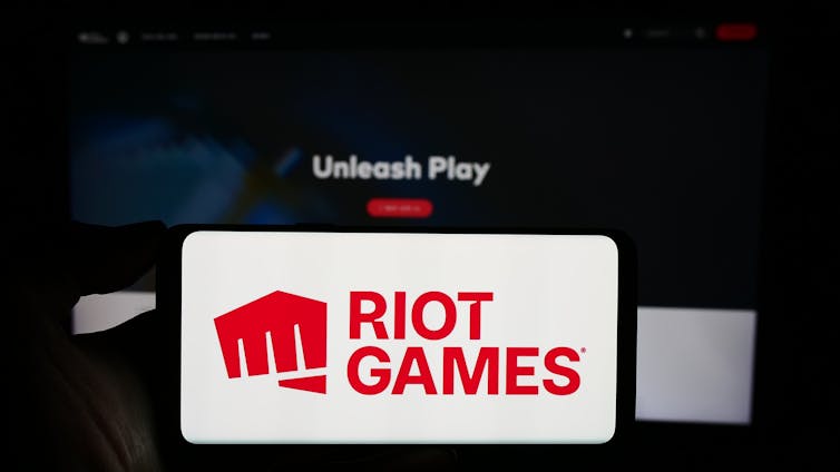 A smartphone displaying the words Riot Games.