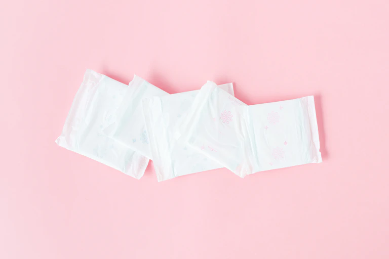 Five sanitary pads in packaging.