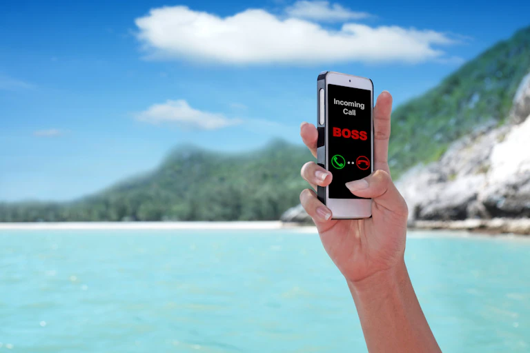 Unidentified hand holding mobile phone showing that the boss is calling