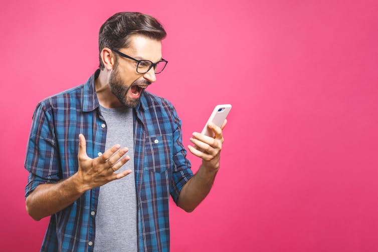 Man shouting at mobile phone