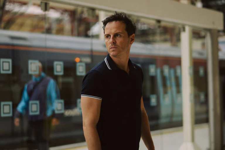 A dark-haired fortysomething man dressed in a blue polo shirt.