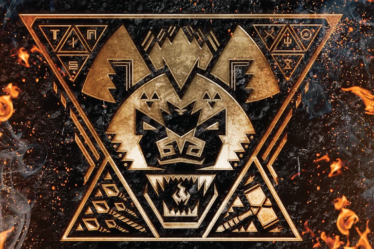 A graphic in gold and black of a hyena's head, mouth open baring teeth, a flame in its mouth.