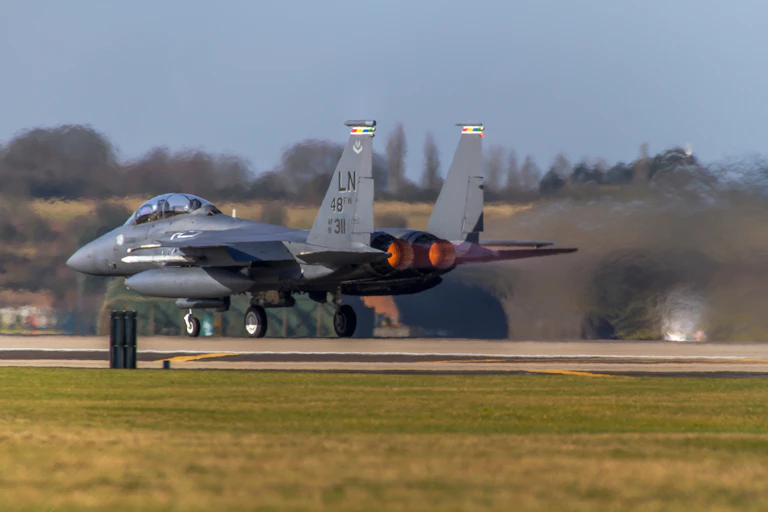 A fighter jet taking off from a runway.