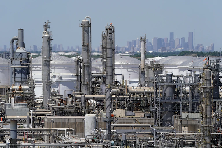Smokestacks and tanks with the Houston skyline in the background
