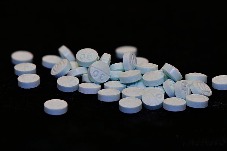 Blue pills on a black background