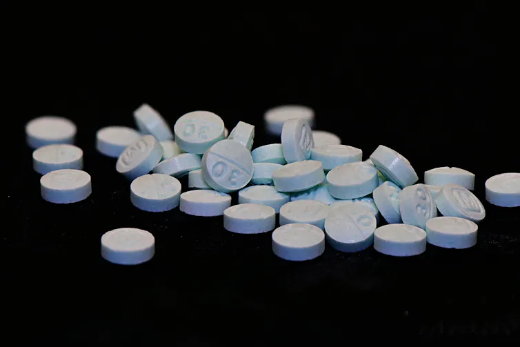 Blue pills on a black background