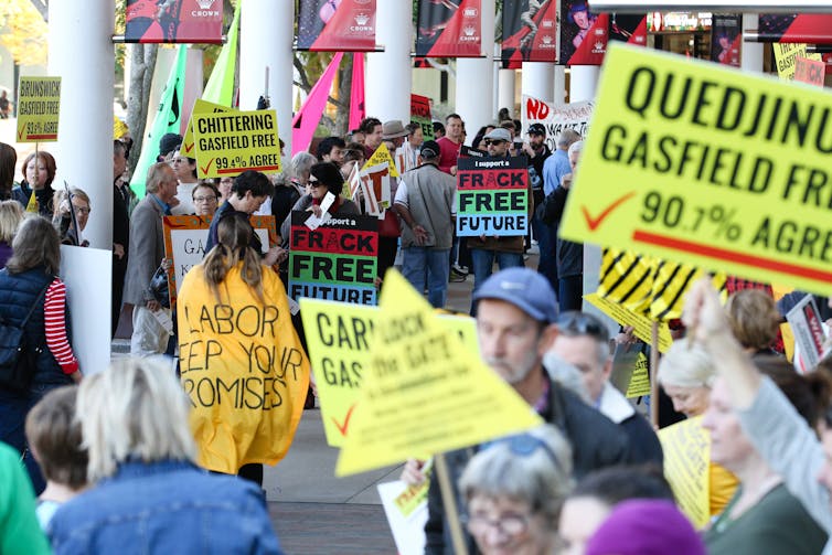 People carrying placards at an environmental protest in Perth
