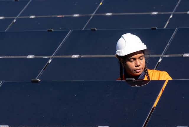 First Nations woman with solar panels