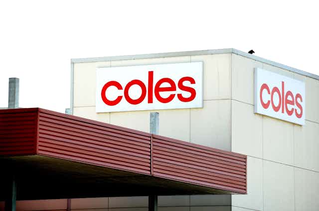 A photo of a Coles sign on a building.