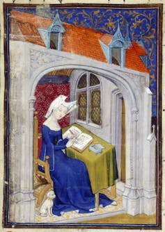 A medieval woman writing a book