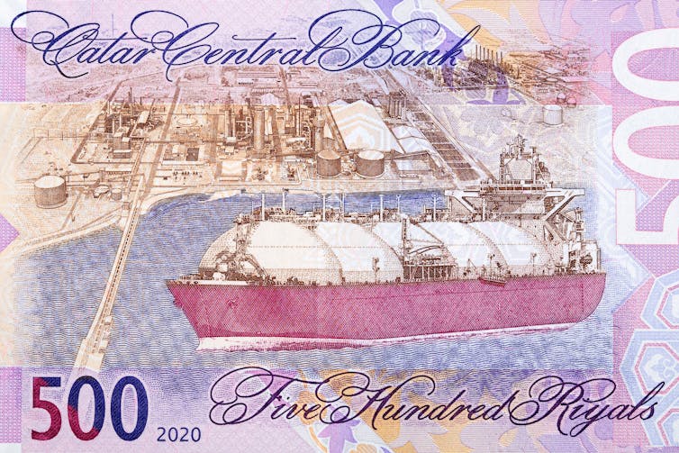A pink bank note with a gas tanker and port on it.