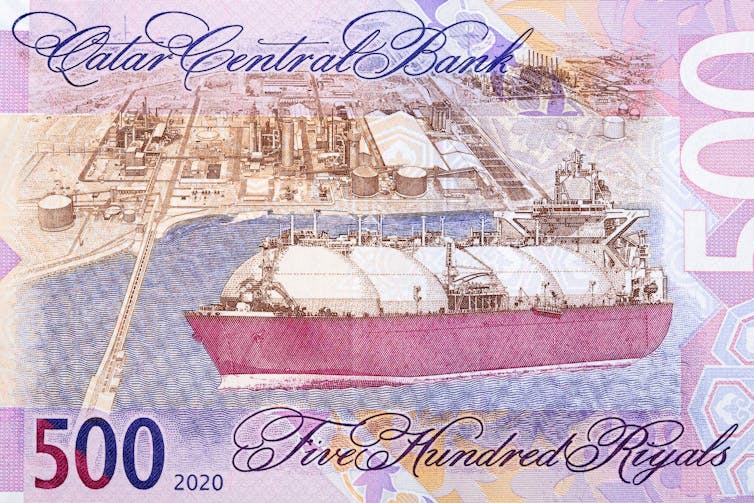 A pink bank note with a gas tanker and port on it.