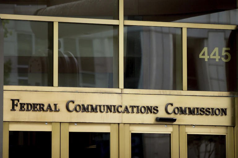 brass and glass entryway of an office building with lettering over the doors
