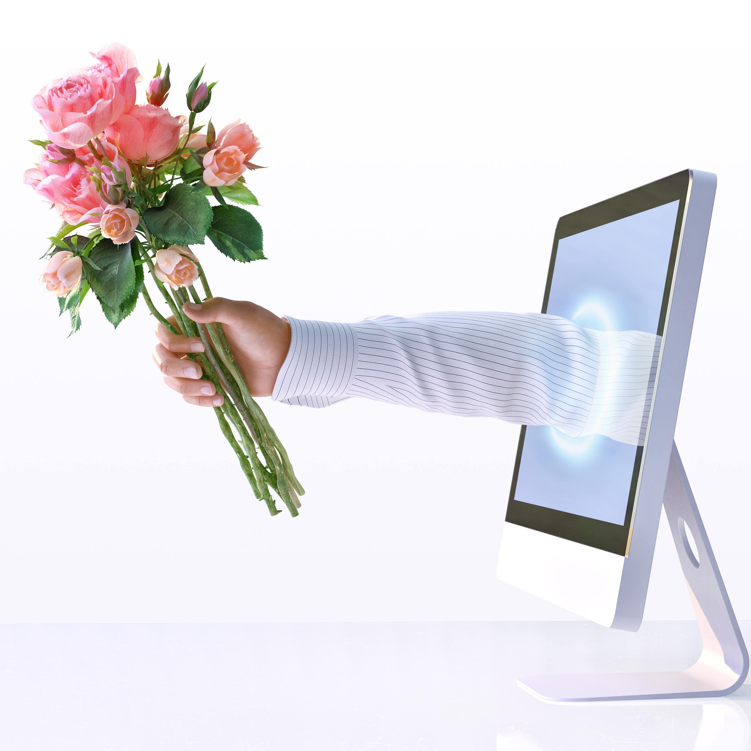 an arm reaching out from a computer screen, holding bouquet of roses